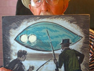 Charlie Hickson showing a painting of the 1973 Pascagoula Abduction UFO. (Image credit: Pat Sullivan, The Mississippi Press)