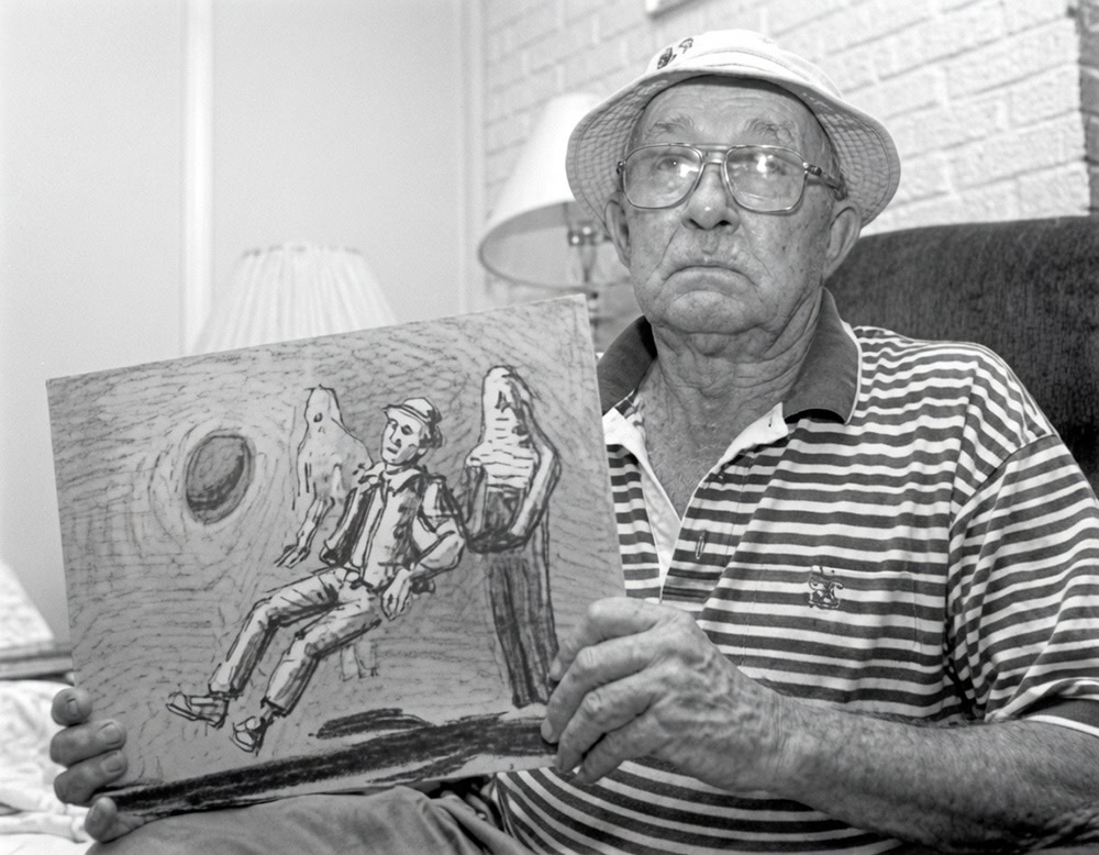Charles Hickson holds drawing of his alleged 1973 UFO Abduction